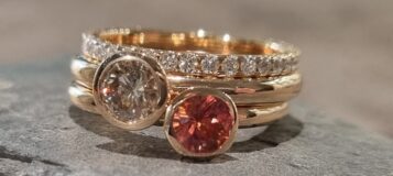 Ringe in 585 Rosegold mit Brillanten und orangefarbenem Saphir